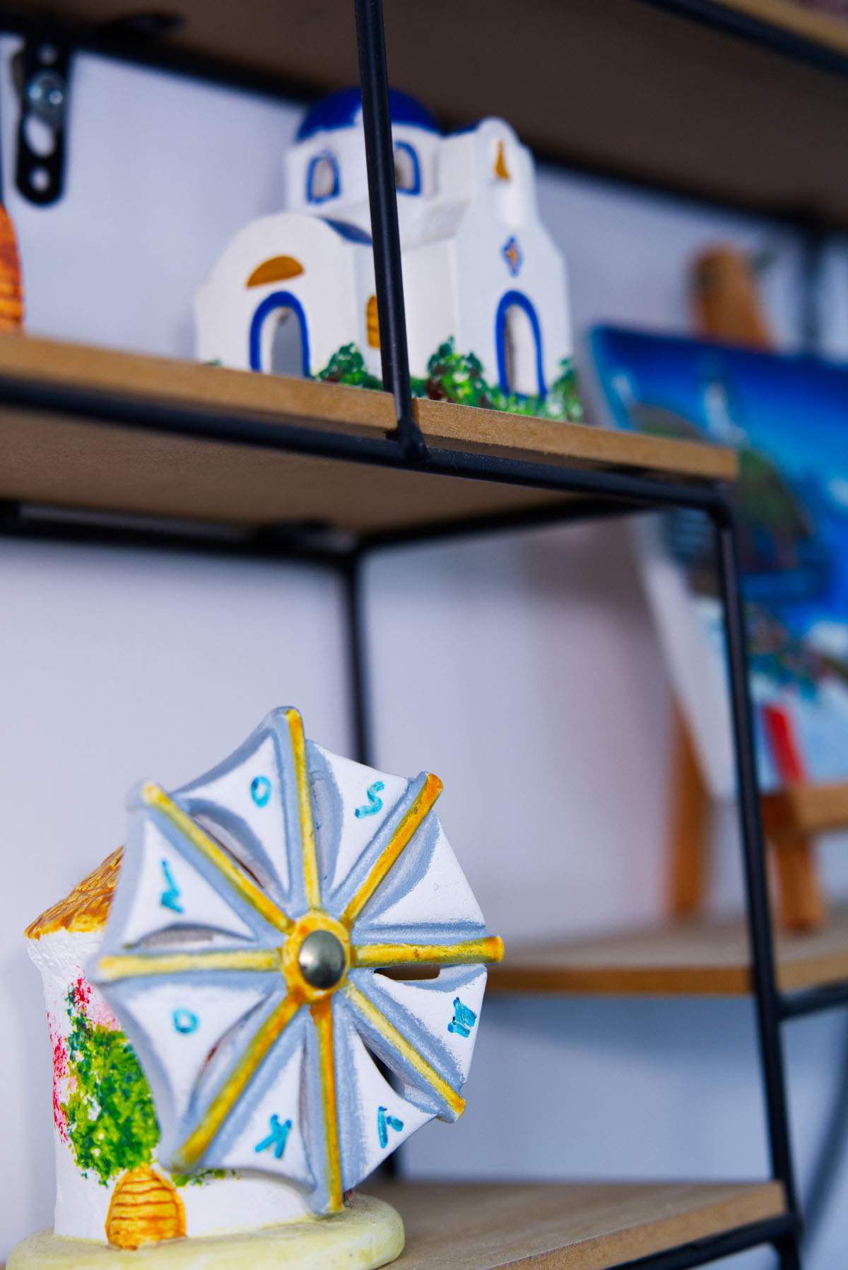A small windmill and a church as decorations in Vento Aureo Mykonos